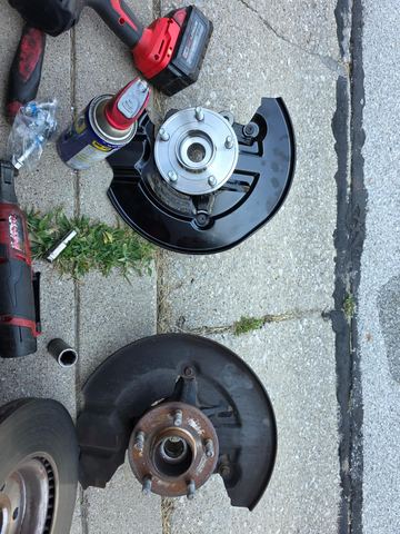 New hub and shield next to the worn-out one
